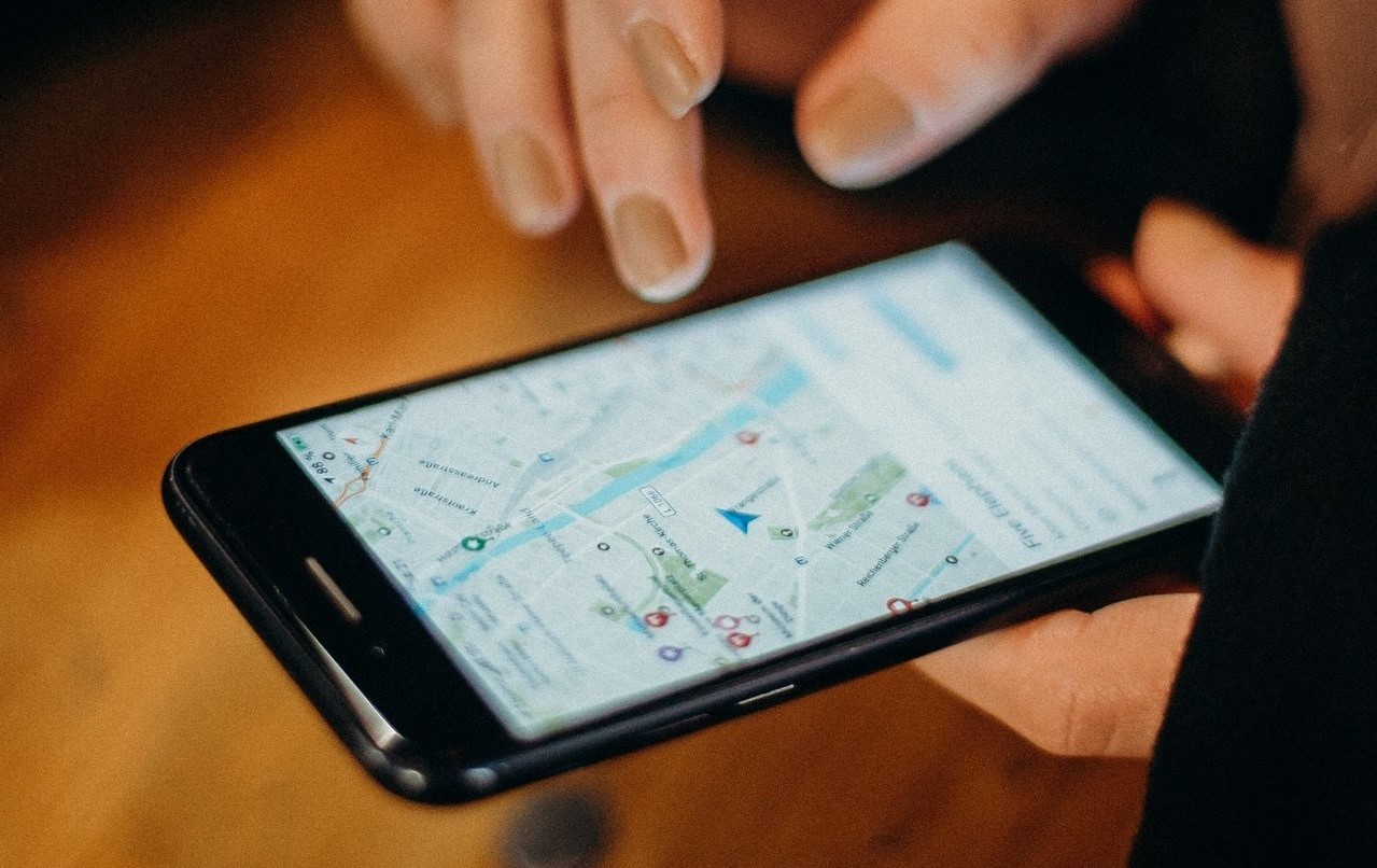 A person searching Google maps on a phone.